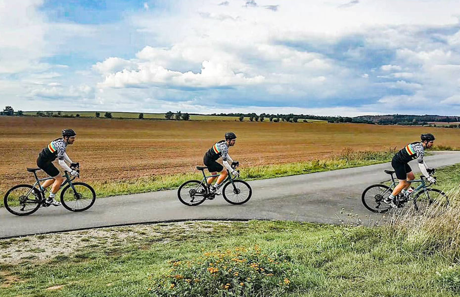 Drei Radfahrer fahren um eine Kurve